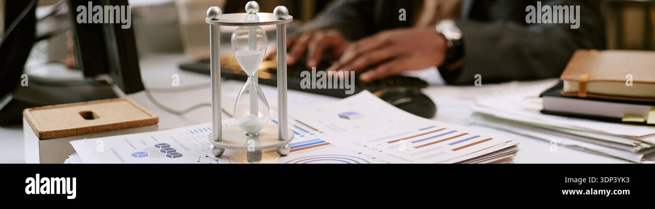 Middle Aged Black Man Analyzing Financial Reports While Working at Desk Stock Photo