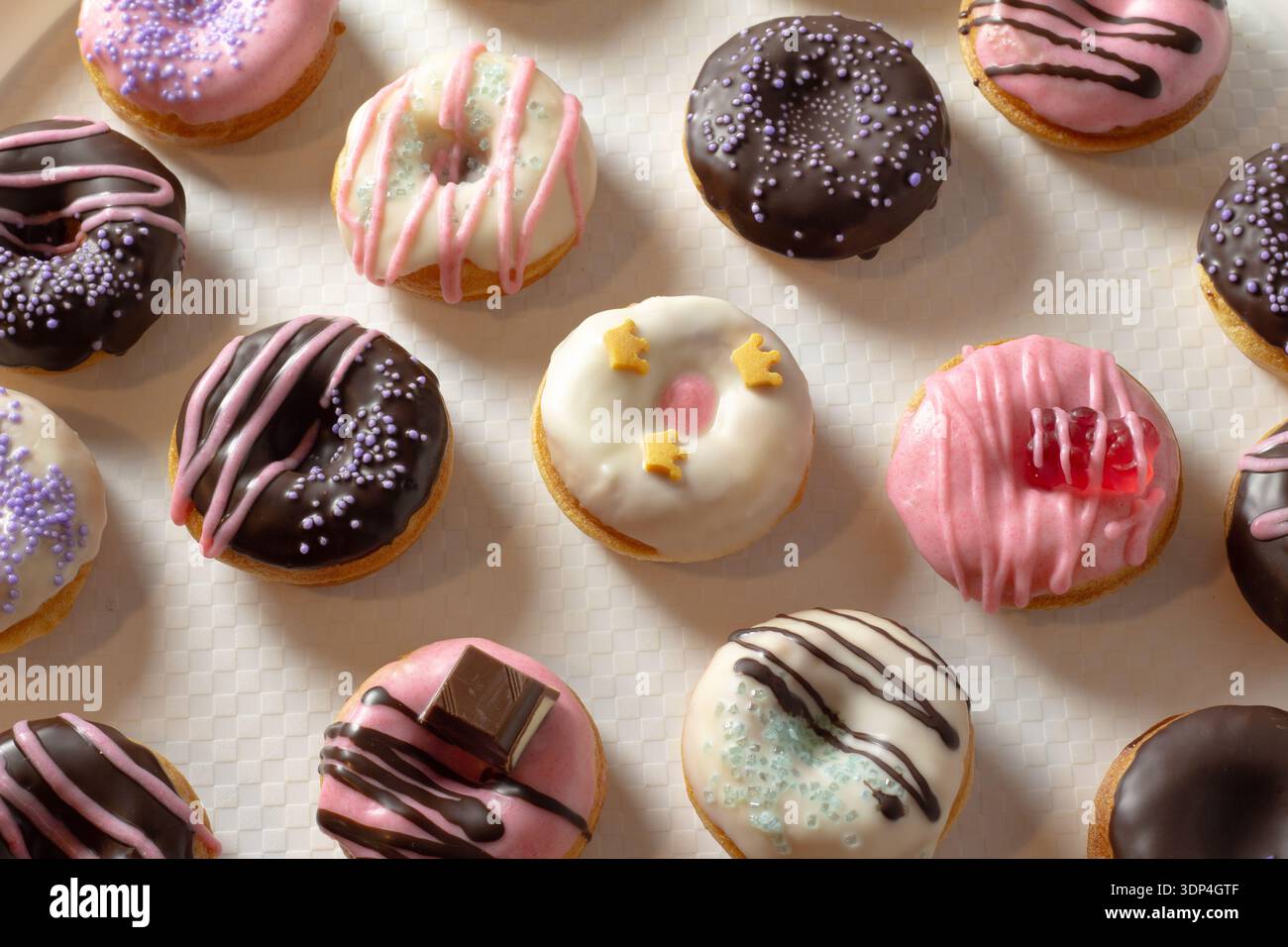 Mini donuts covered in chocolate on a white background. Close-up Stock Photo
