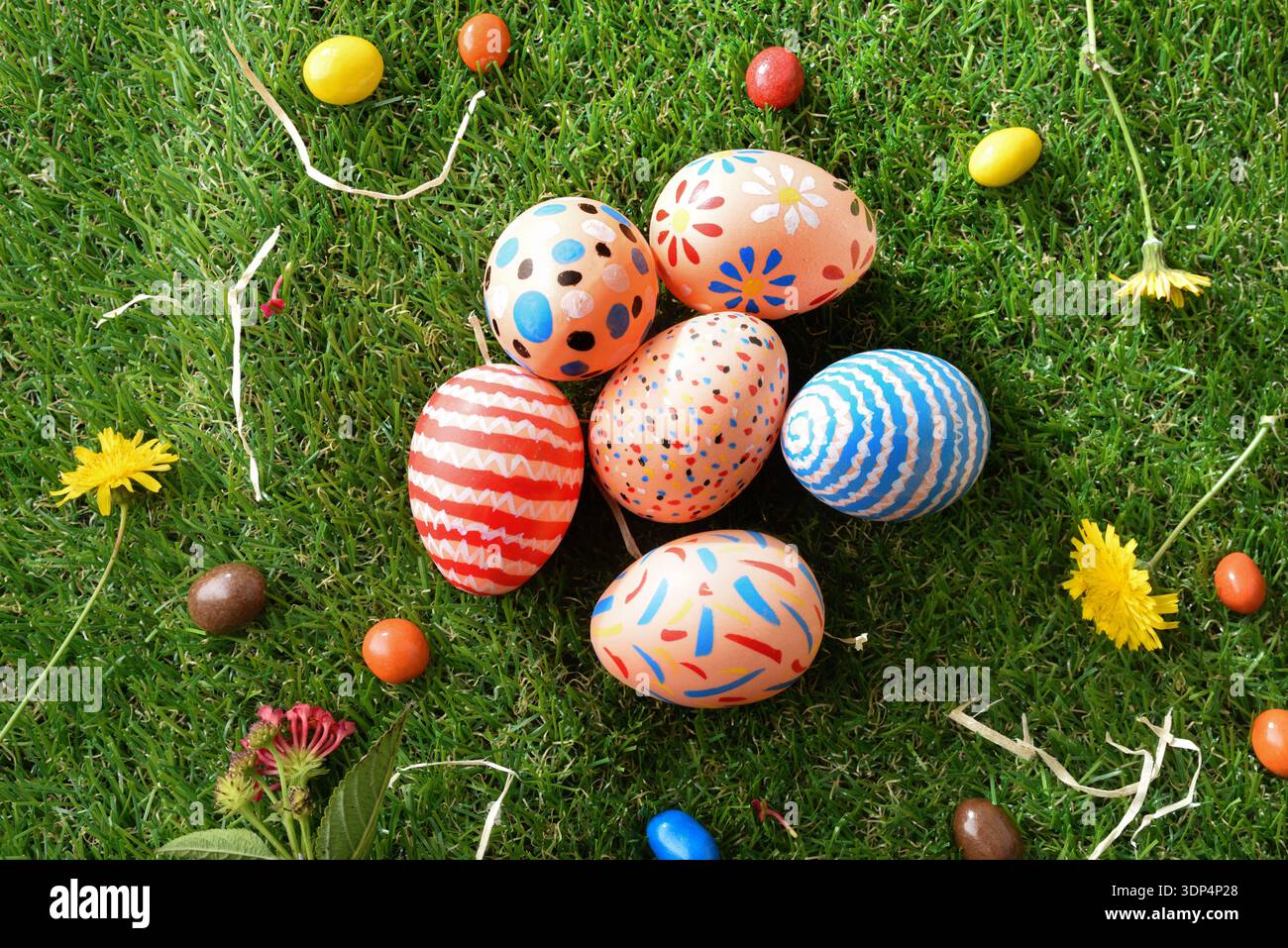 Colorful Hand-Painted Easter Eggs on Grass Stock Photo