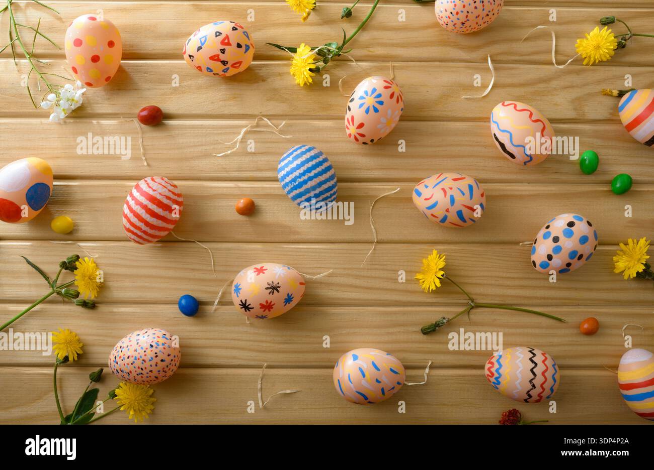 Scattered Colorful Easter Eggs on Wooden Background Stock Photo