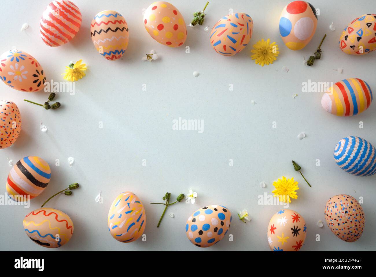 Colorful Easter Eggs Frame with Spring Flowers Stock Photo