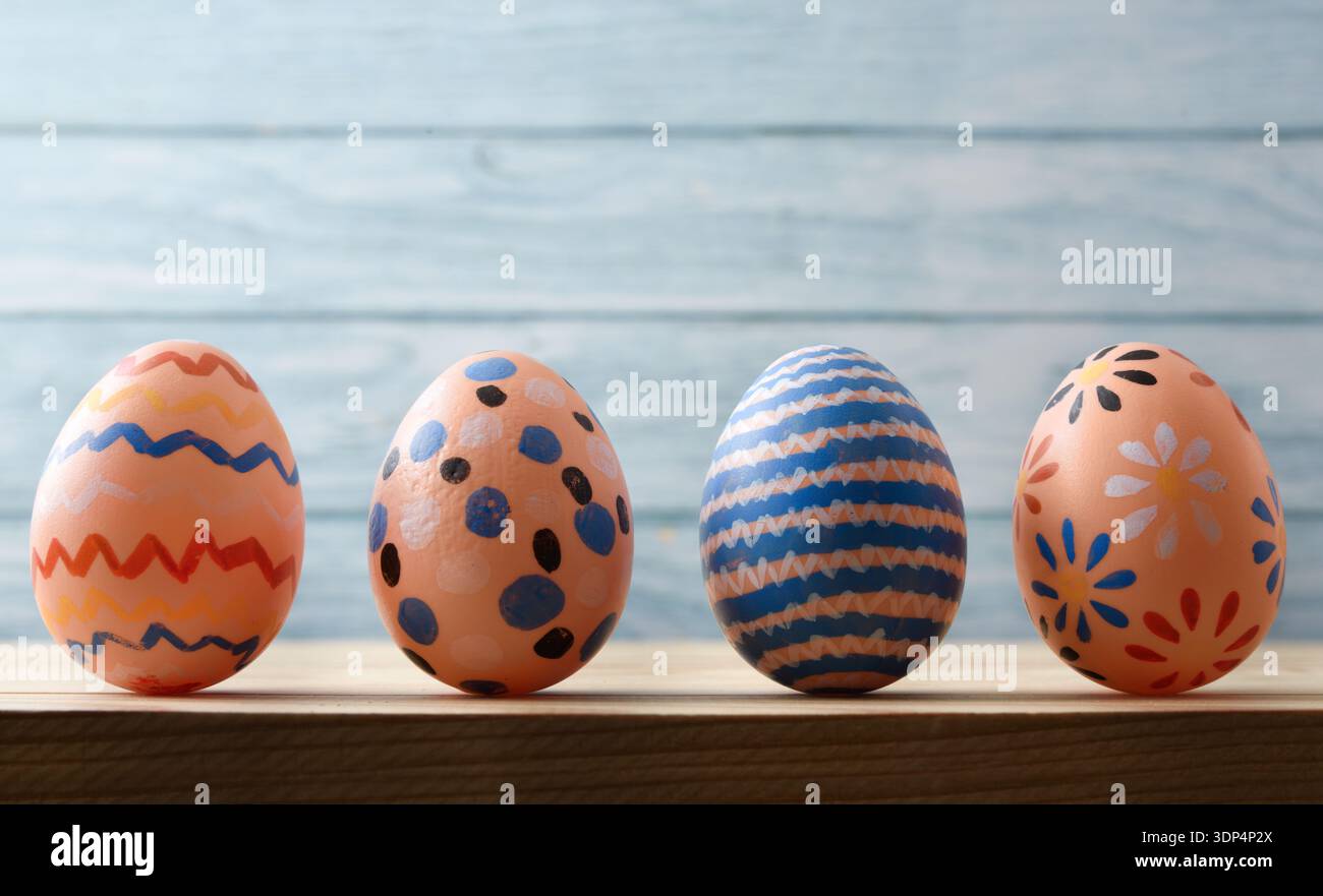Hand-Painted Easter Eggs on Wooden Background Stock Photo