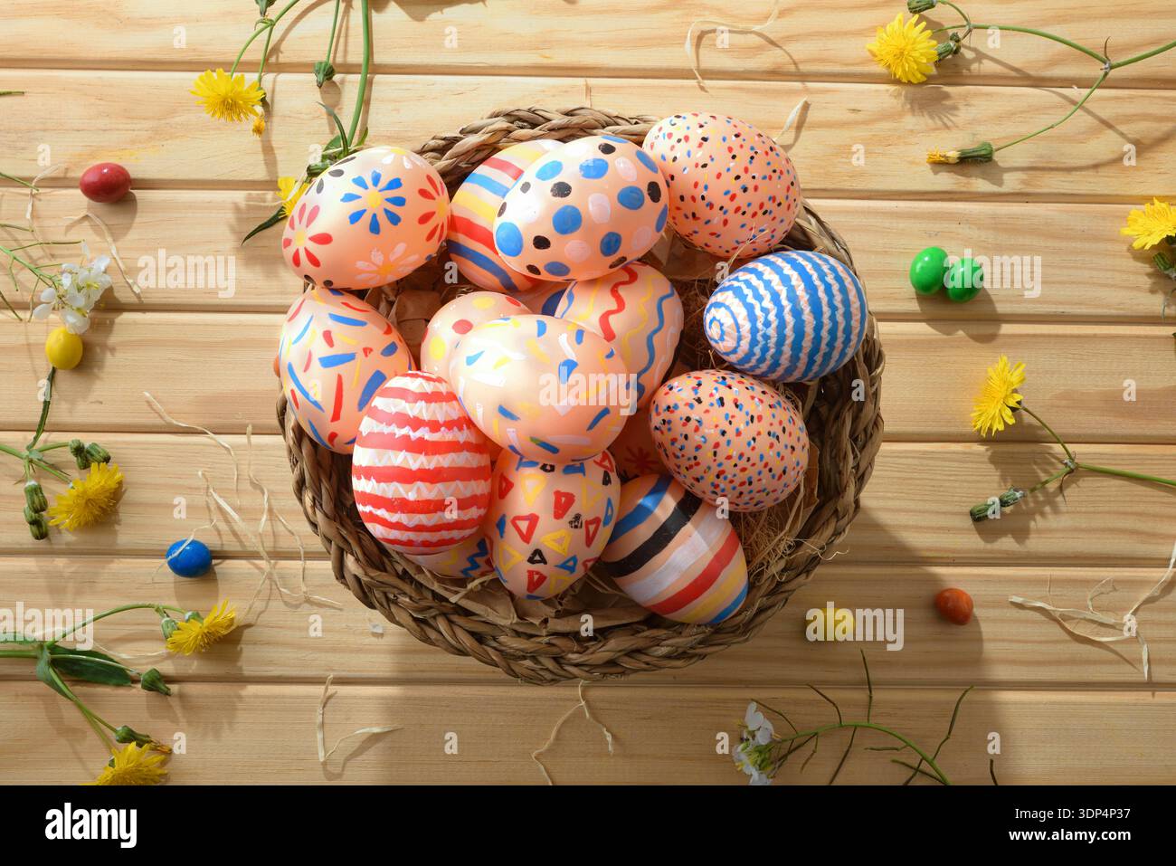 Colorful Easter Eggs in Rustic Wicker Basket Stock Photo