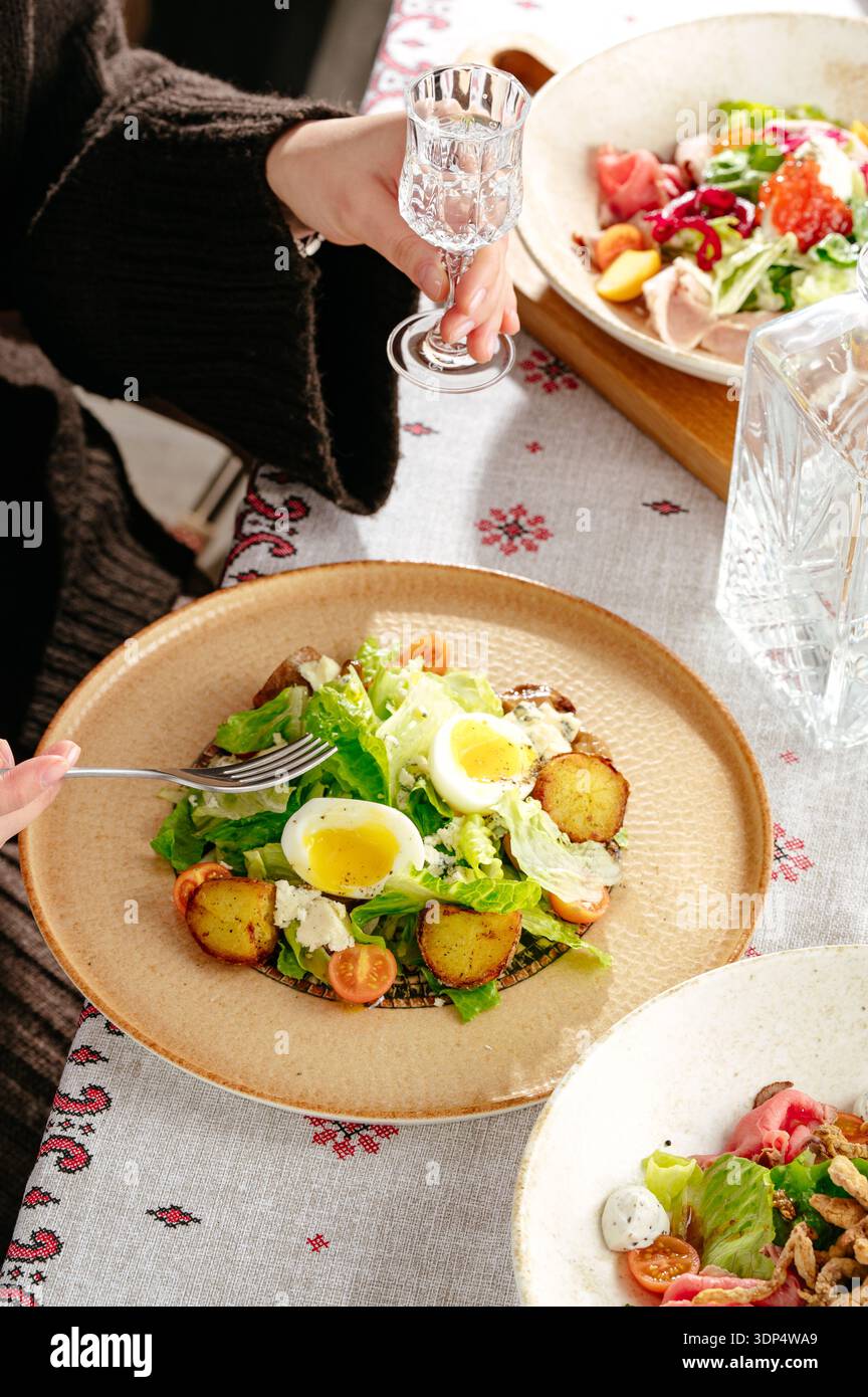 salad with eggs Benedict and herbs Stock Photo