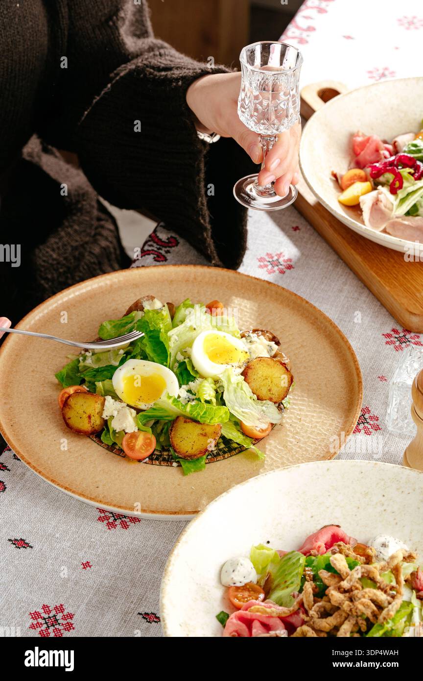 salad with eggs Benedict and herbs Stock Photo