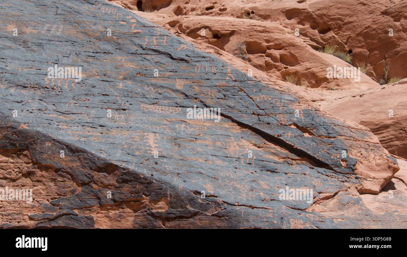 Highlights On Rocks A detailed view of petroglyphs etched into weathered sandstone. The ...