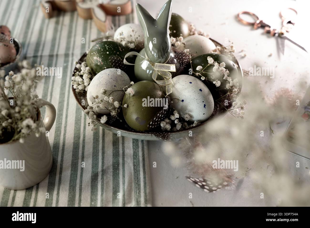 Rustic Easter still life with olive eggs and decor. Stock Photo