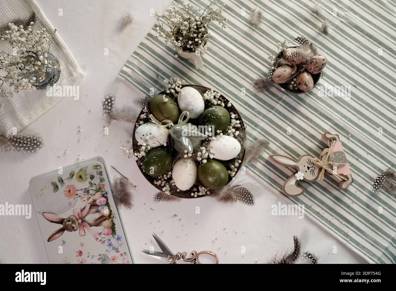 Rustic Easter still life with olive eggs and decor. Stock Photo