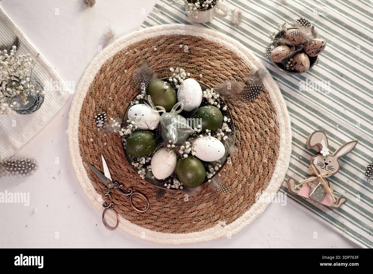 Rustic Easter still life with olive eggs and decor. Stock Photo