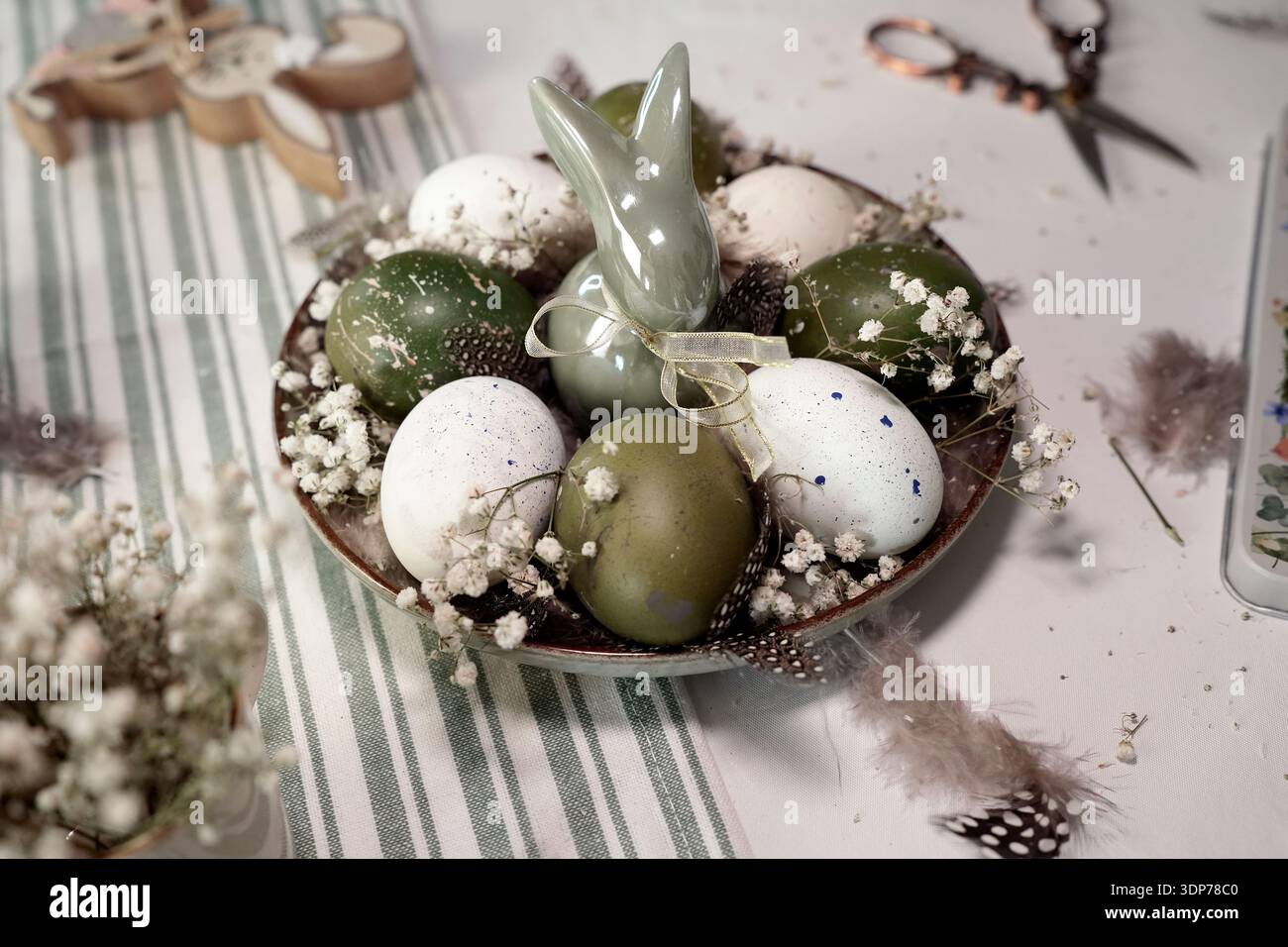 Rustic Easter still life with olive eggs and decor. Stock Photo
