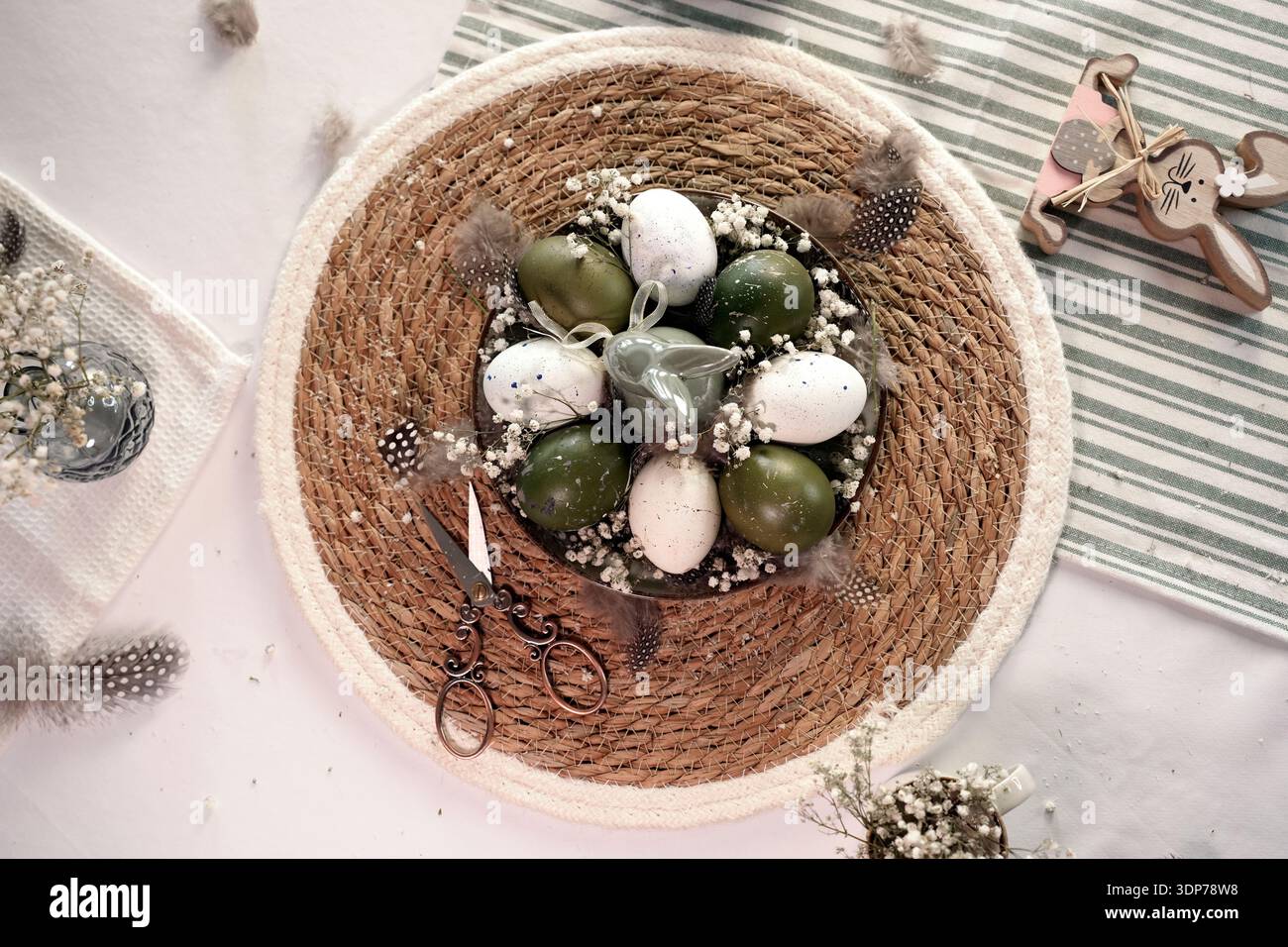Rustic Easter still life with olive eggs and decor. Stock Photo