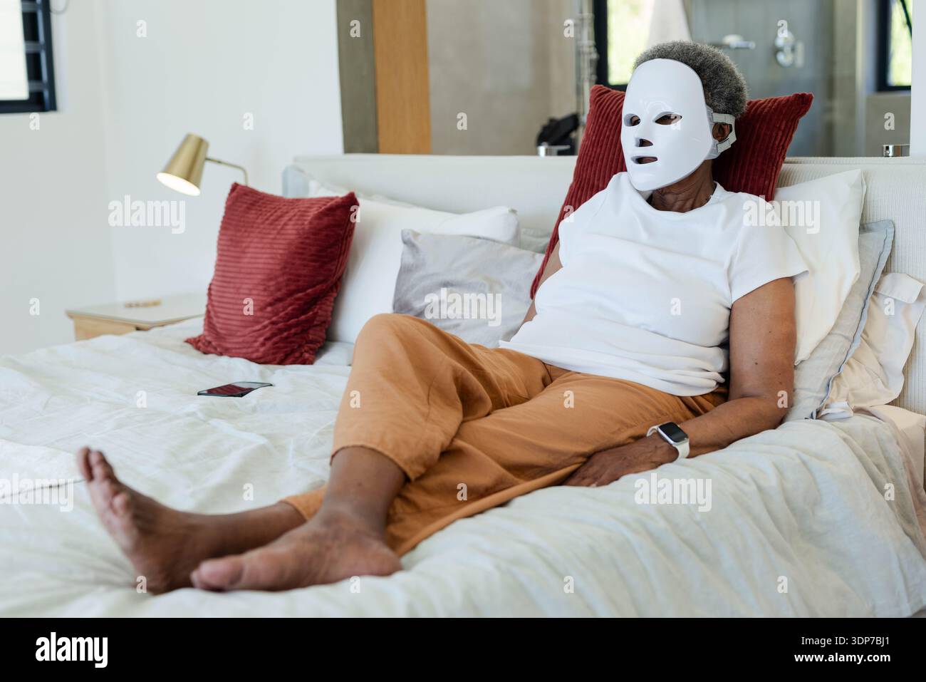 Black woman wearing sheet mask hi-res stock photography and images - Alamy