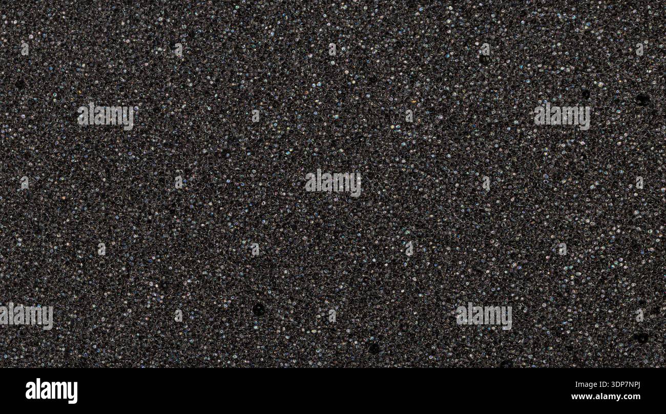 Black foam displaying a uniform porous surface texture suitable for various design backgrounds Stock Photo