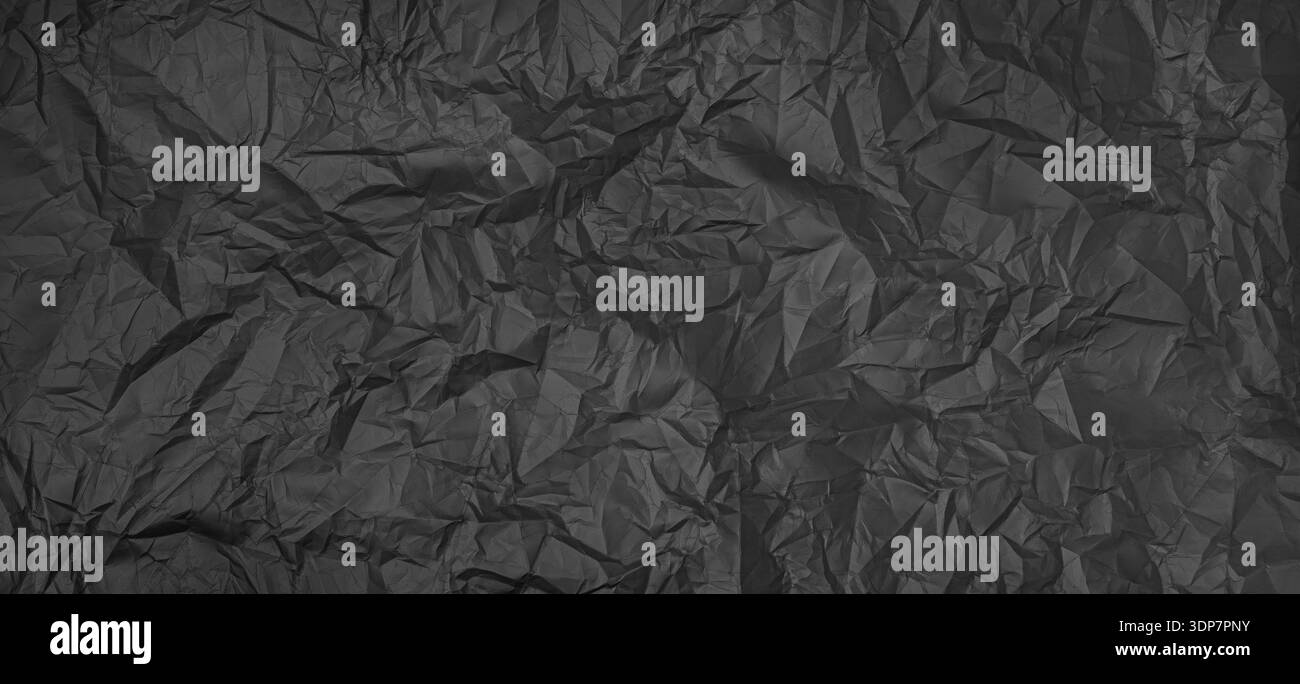 Crumpled black paper surface showing texture and abstract patterns Stock Photo