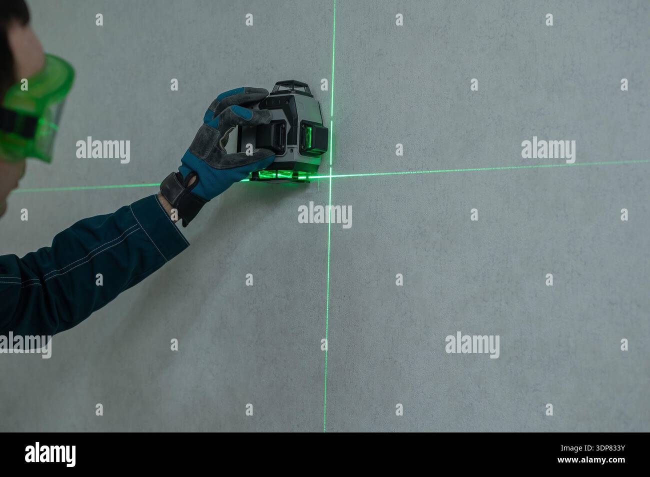 A man measures distance with a laser level.  Stock Photo