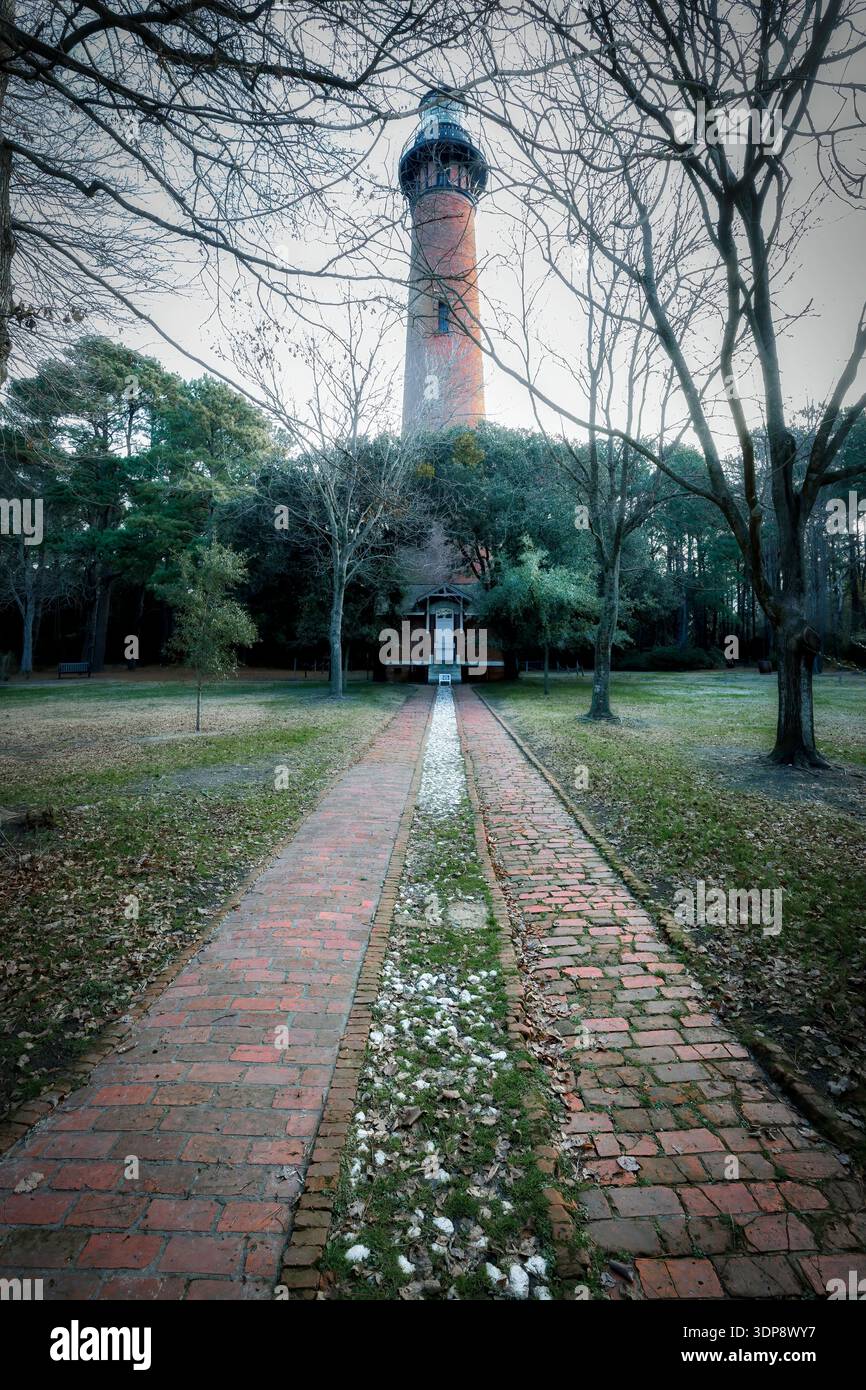 A wintery day at the brick path that leads to the Currituck Beach Light, built in 1875 and located between the Cape Henry and Bodie Island Lights at C Stock Photo