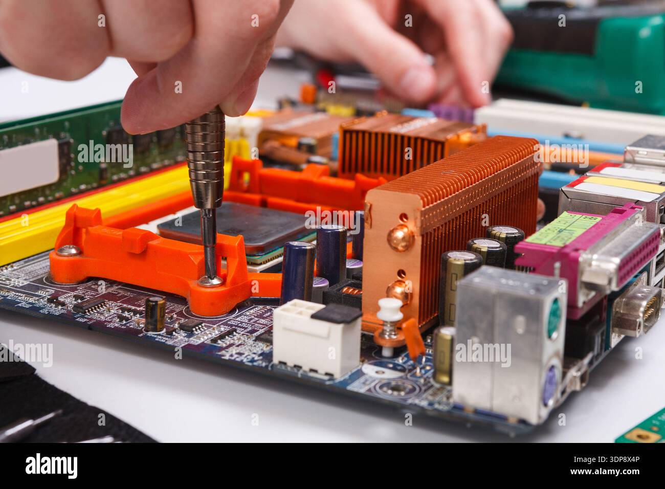 Engineer checking motherboard with multimeter Stock Photo