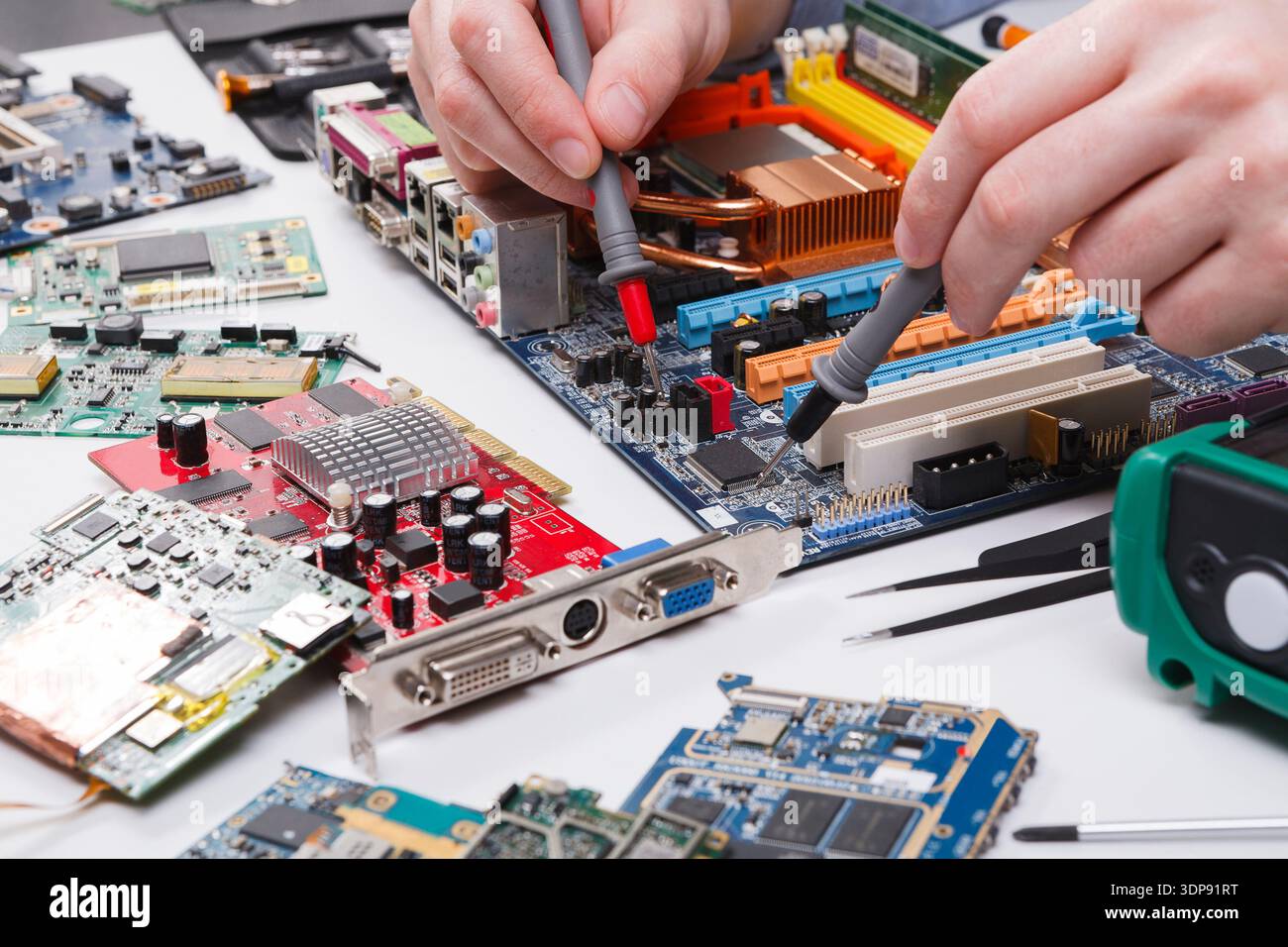 Engineer checking motherboard with multimeter Stock Photo