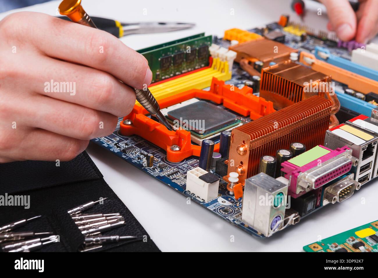 Engineer checking motherboard with multimeter Stock Photo