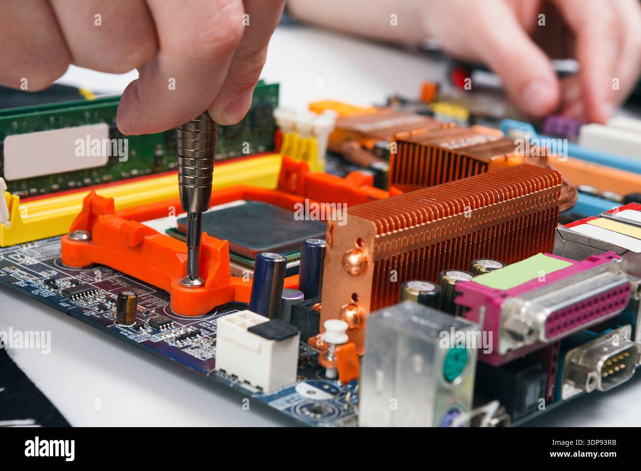 Engineer checking motherboard with multimeter Stock Photo