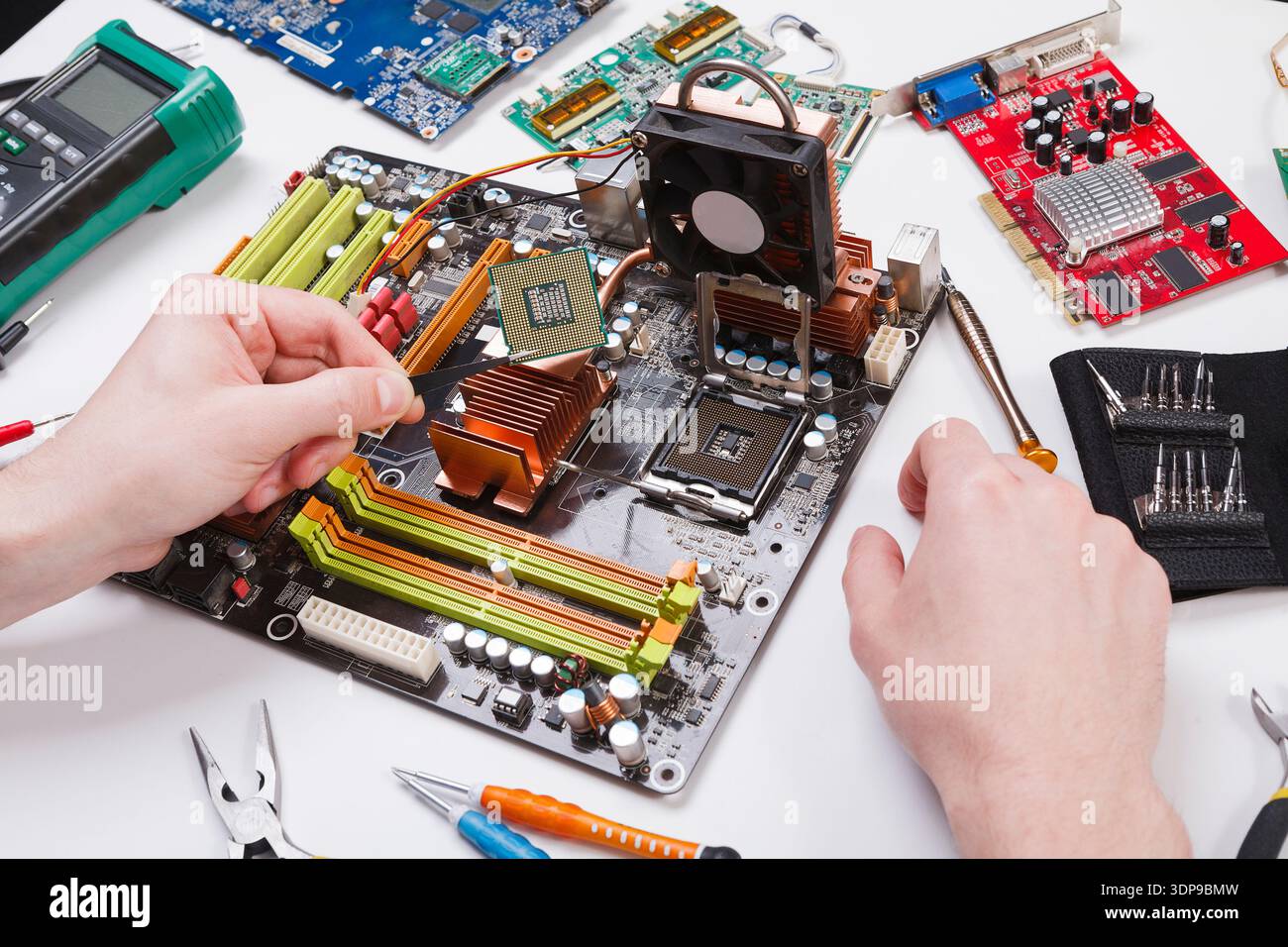 Technician plug in microprocessor to motherboard Stock Photo