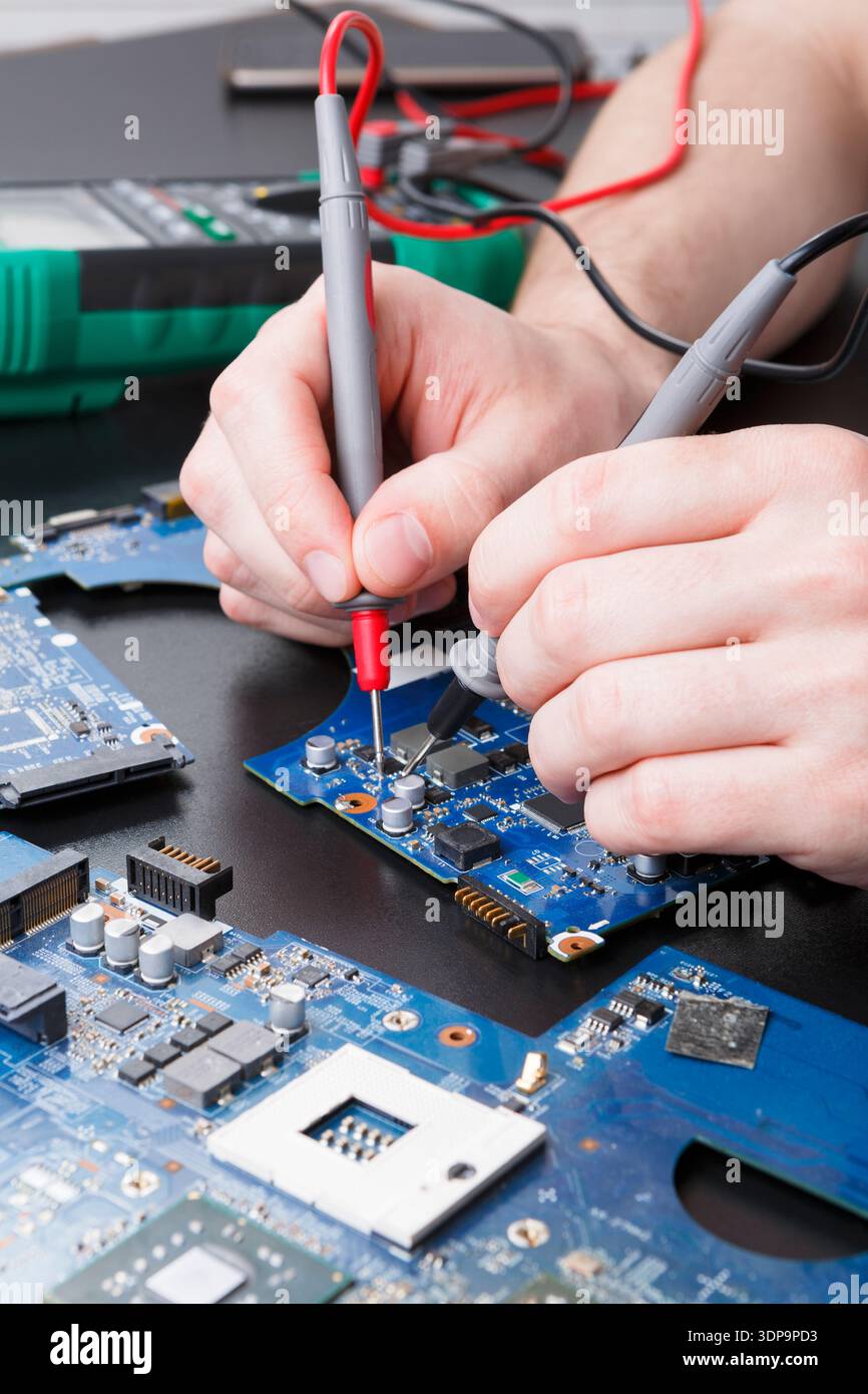 Laptop motherboard testing in service center Stock Photo