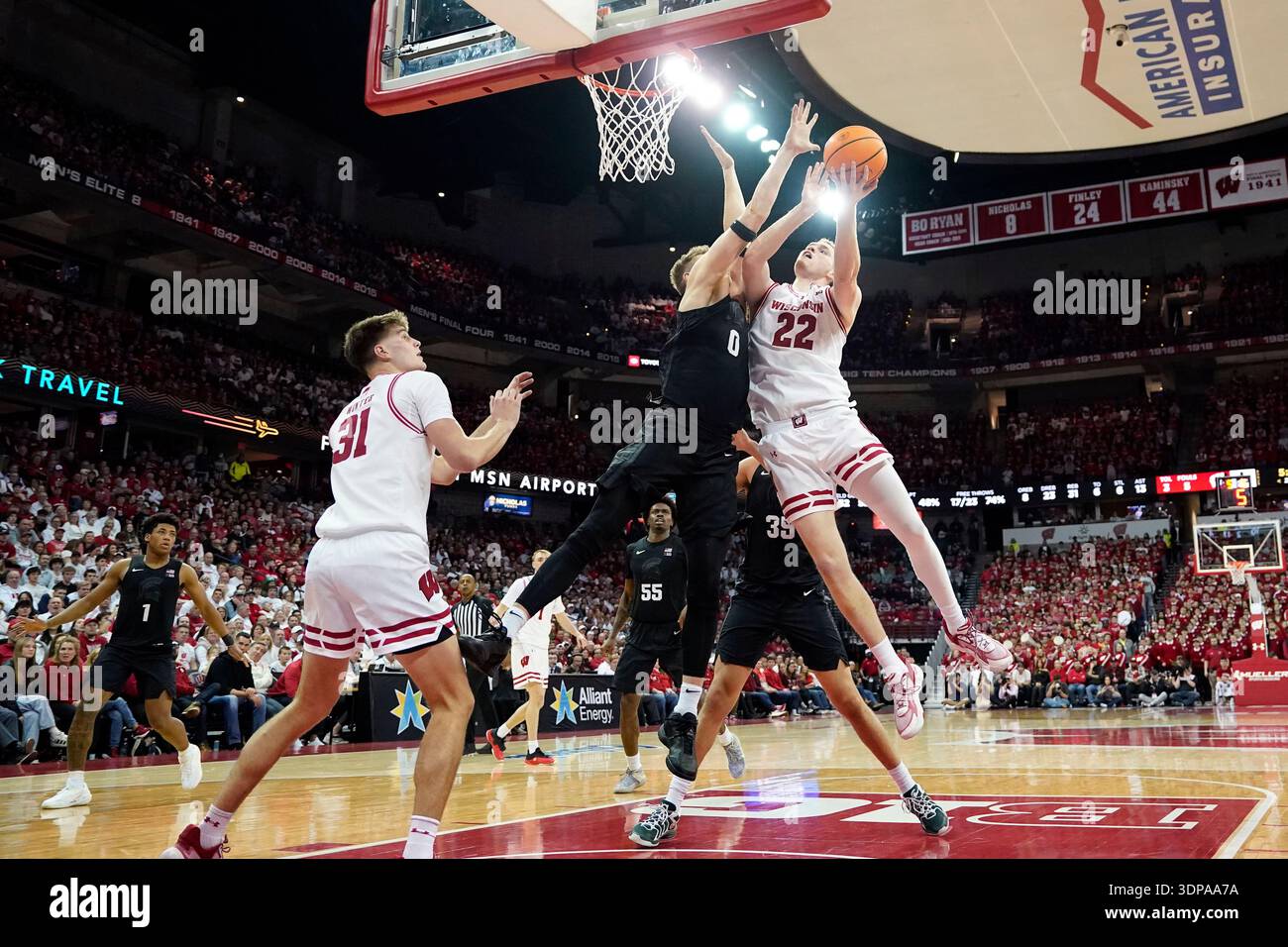 Wisconsin forward Austin Rapp (22) attempts a basket against Michigan ...