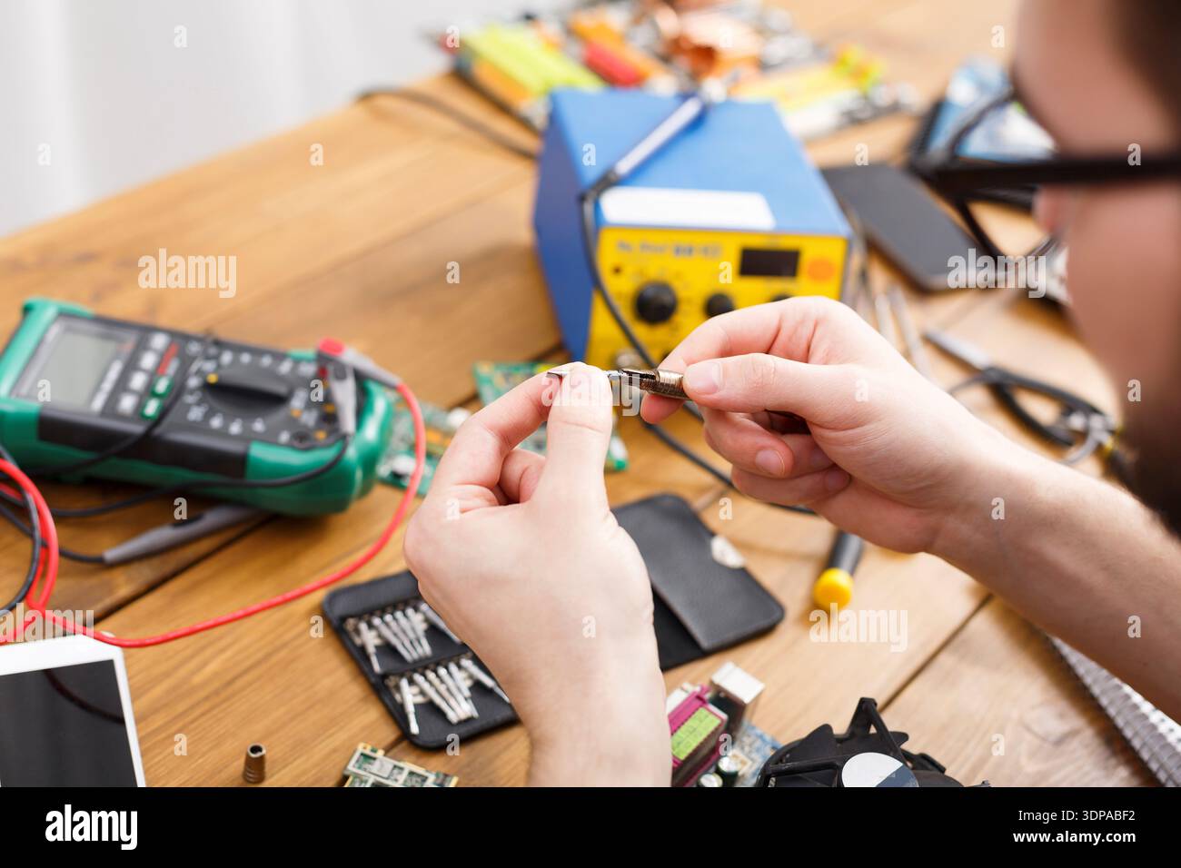 Repairing Electronic Components With Tools on a Workbench in a Workshop Environment Stock Photo