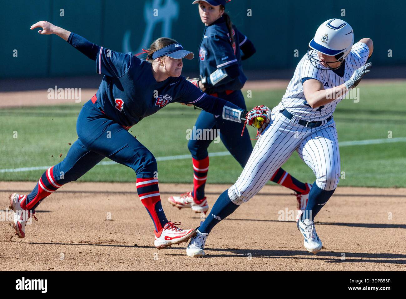 Softball Rundown Liberty infielder Maci Strickland (4) gets Georgia Southern outfielder ...