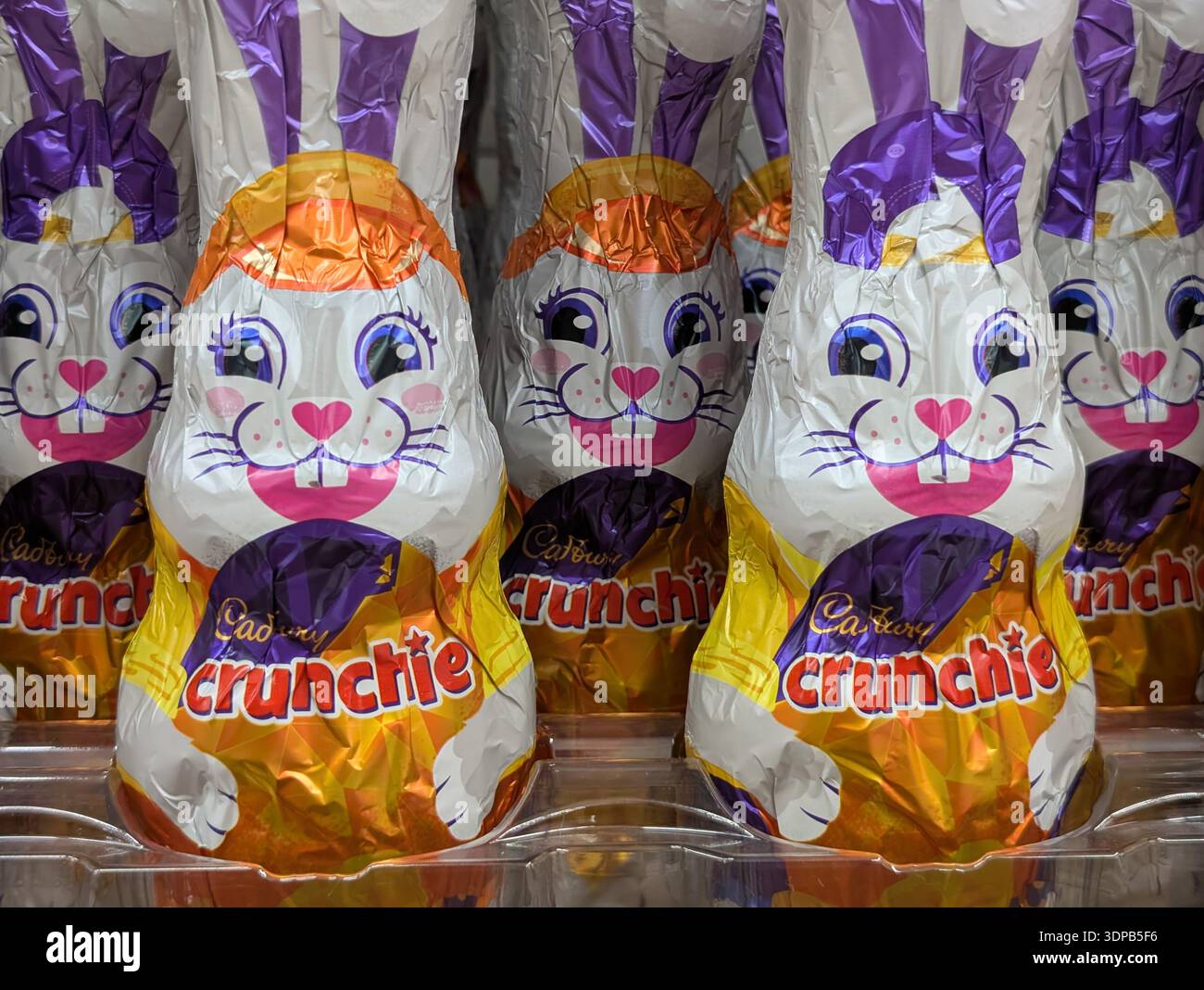 Cadbury Crunchie chocolate bunnies on display inside a supermarket in Australia - Smartphone Captured Stock Image