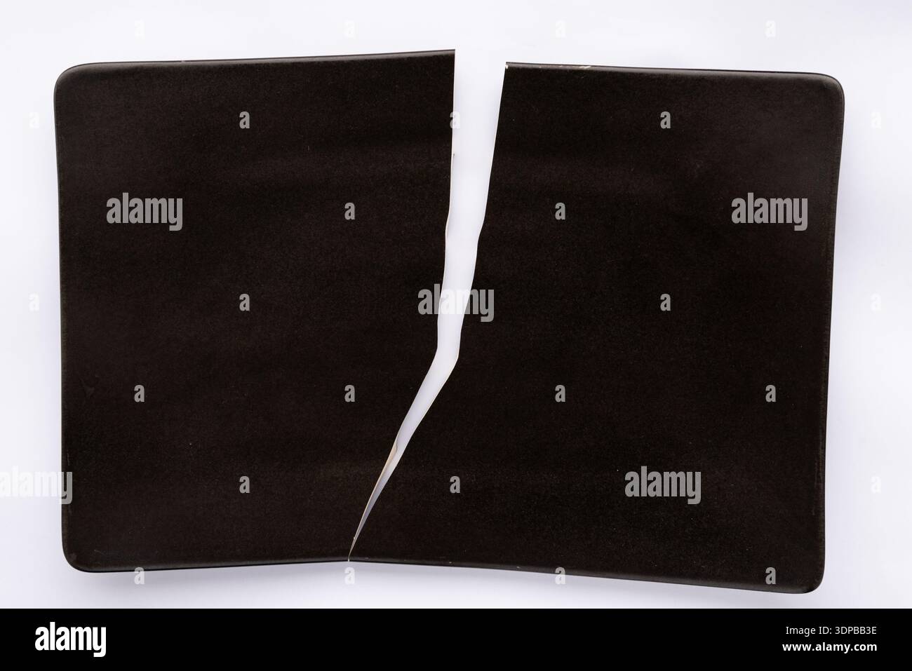 Broken black plate Stock Photo