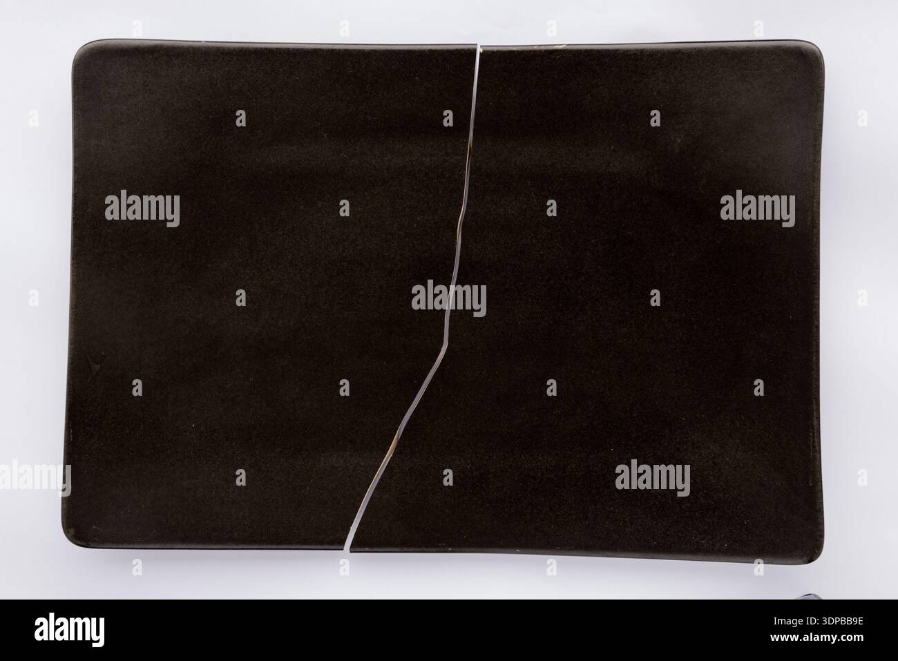 Broken black plate Stock Photo