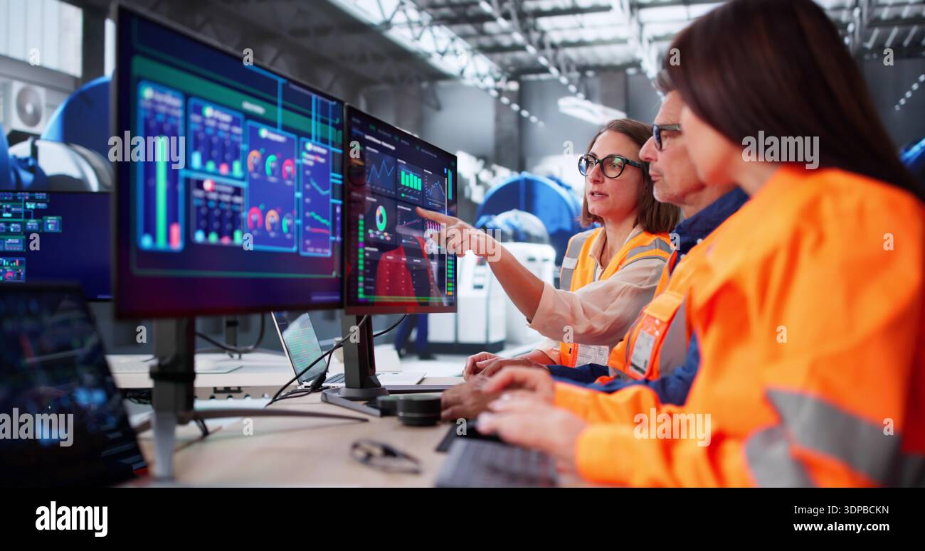 Modern SCADA Room: Engineers Meeting Maintenance Operator At Control Panel Stock Photo