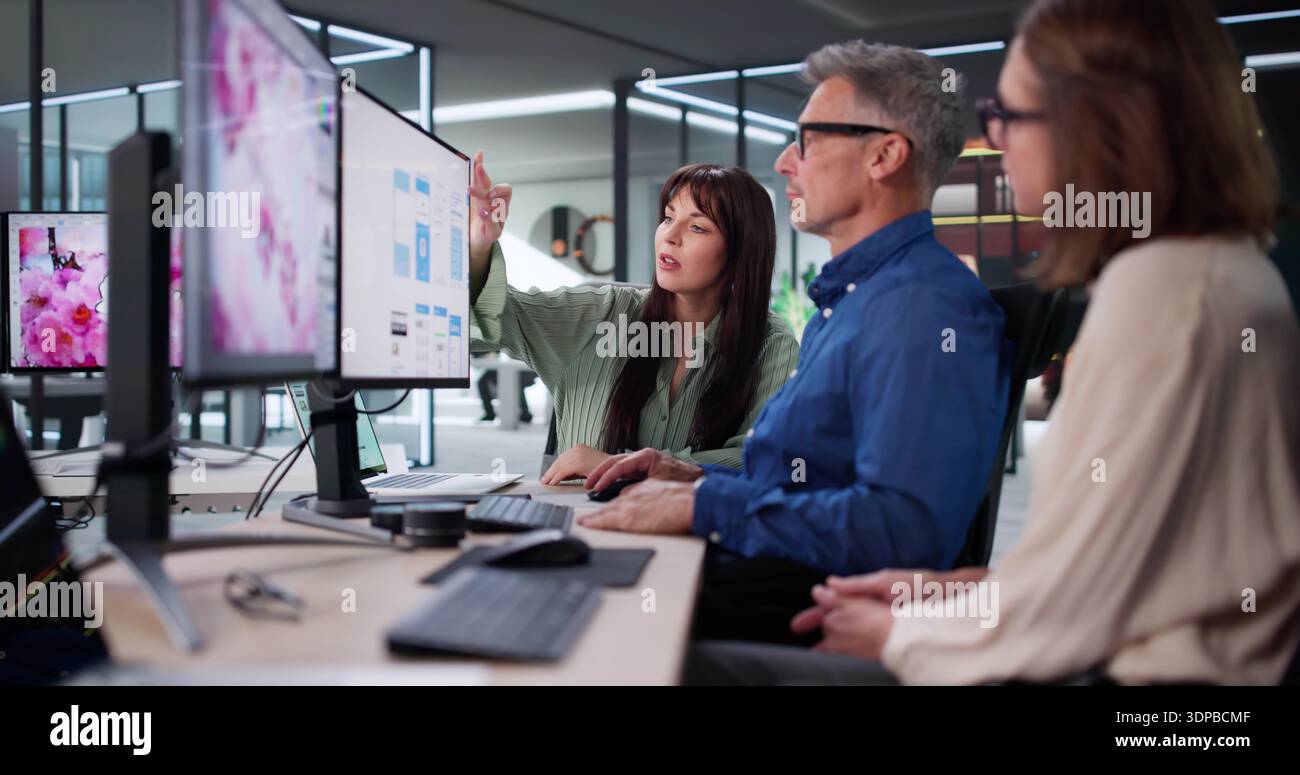 Experienced Graphic Designer And Young Web Developer Discussing Project Collaboration. Stock Photo