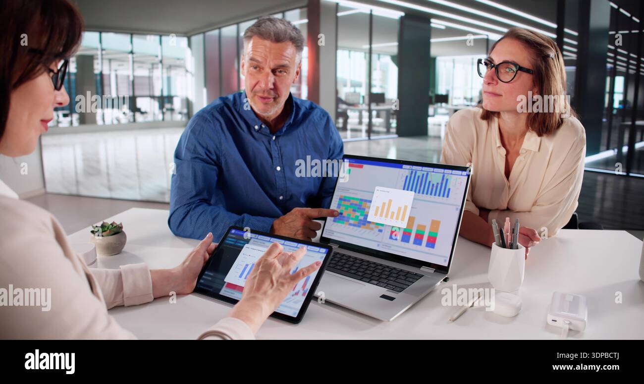 Multicultural Financial Analysts Meet To Discuss Key Performance Indicators. Stock Photo
