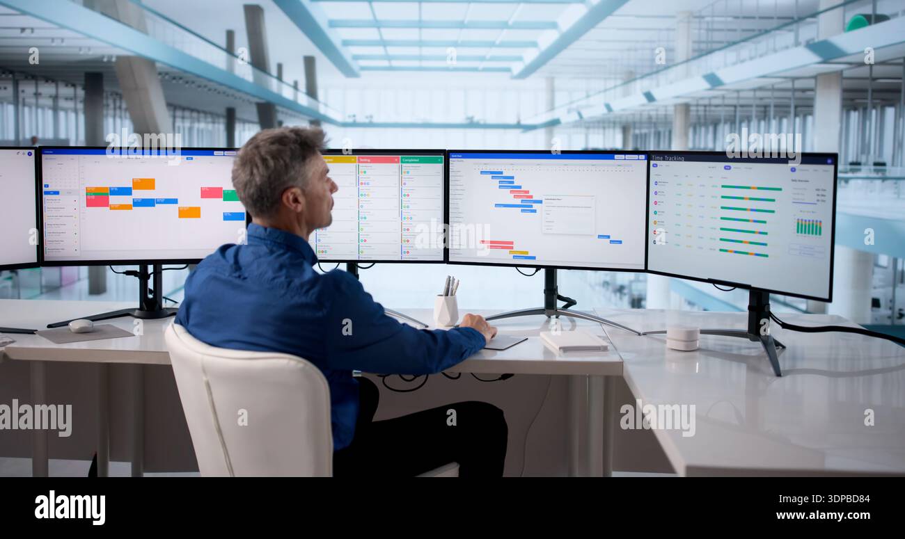 Man Using Scheduling Software To Manage Business Calendar Events Efficiently. Stock Photo
