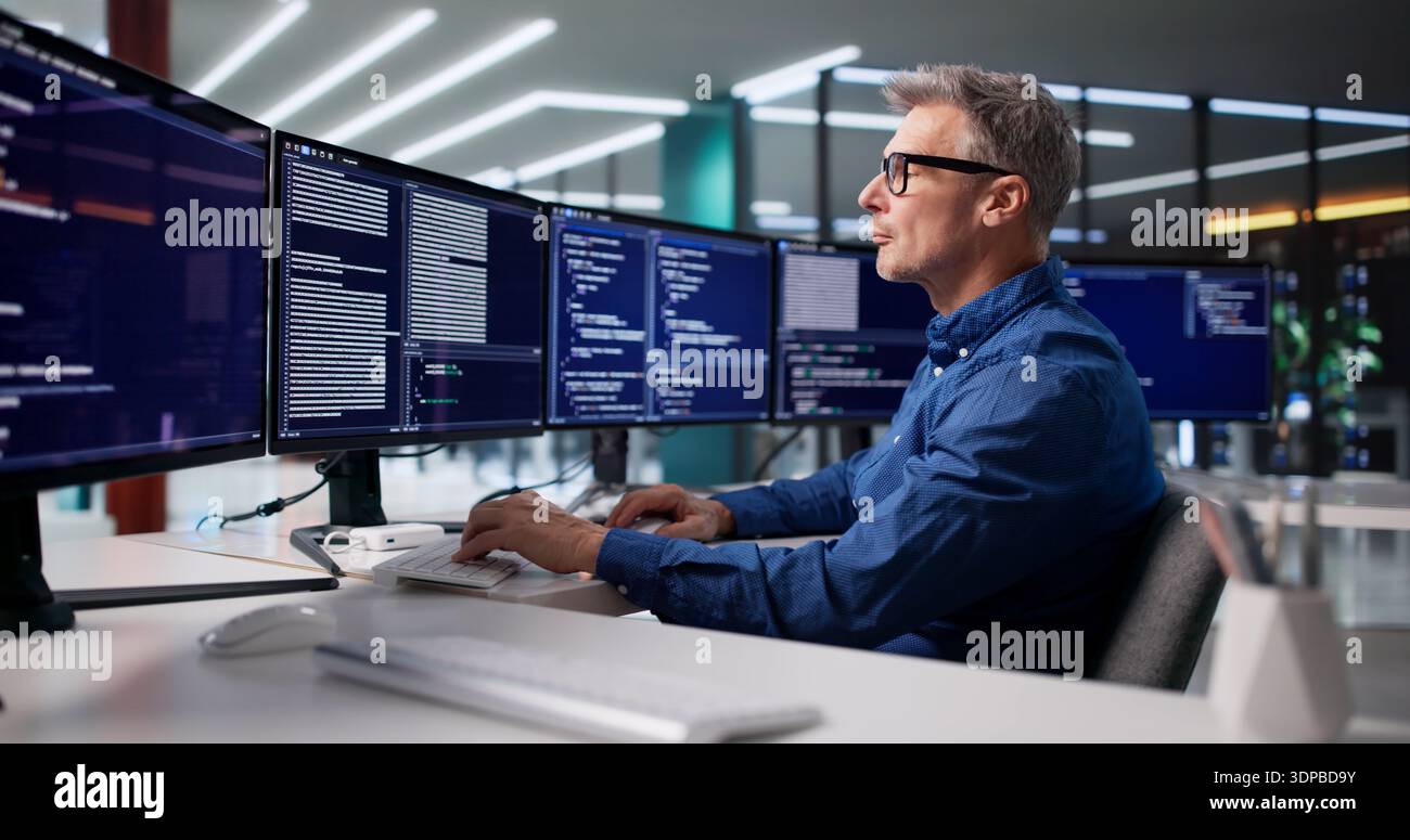 Focused Programmer Develops Cyber Security Software For Business In Office Stock Photo