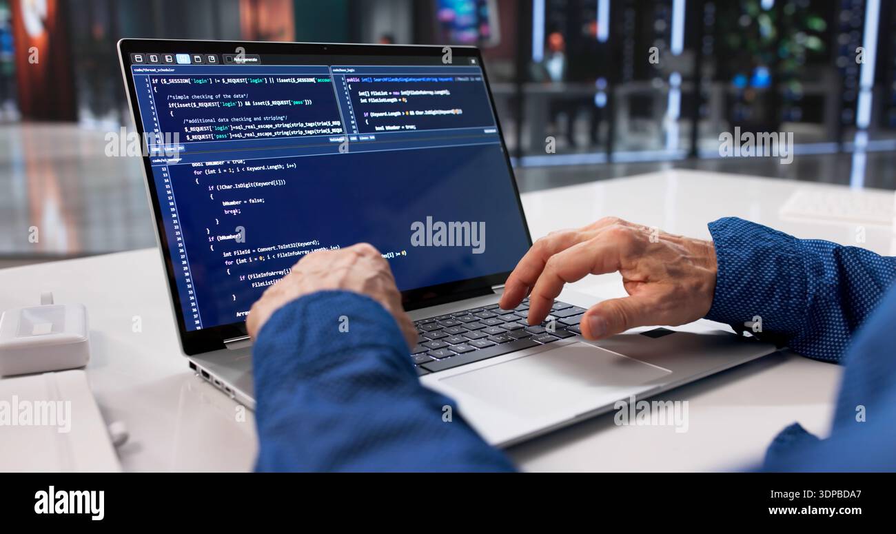 Male Programmer Writing Code For Web Software Engineering Project During Office Hours. Working On Security Measures Stock Photo