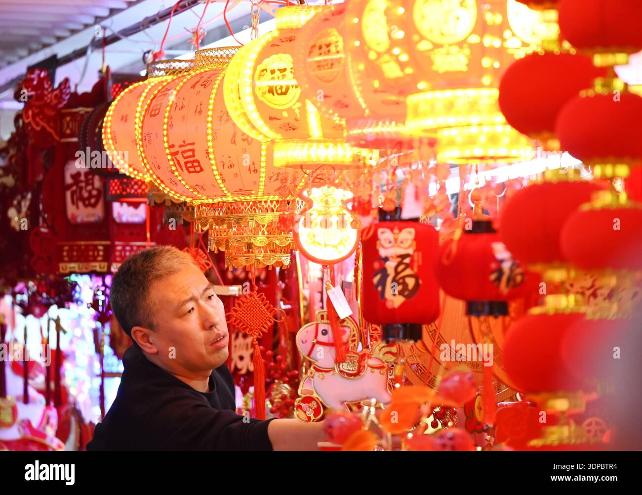 Shoppers select Spring Festival decorations at Beijing Baihong World ...
