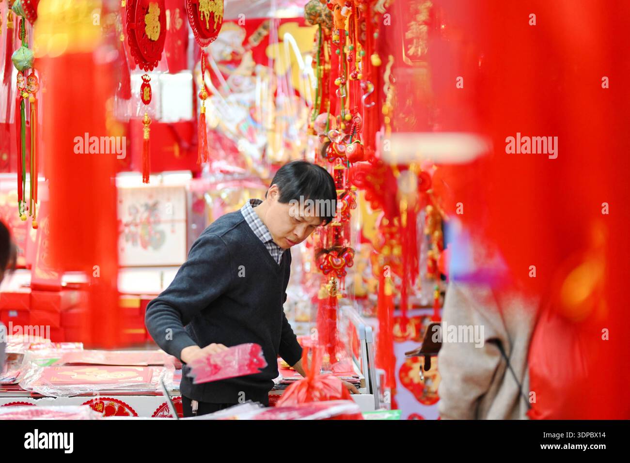 Shoppers select Spring Festival decorations at Beijing Baihong World ...