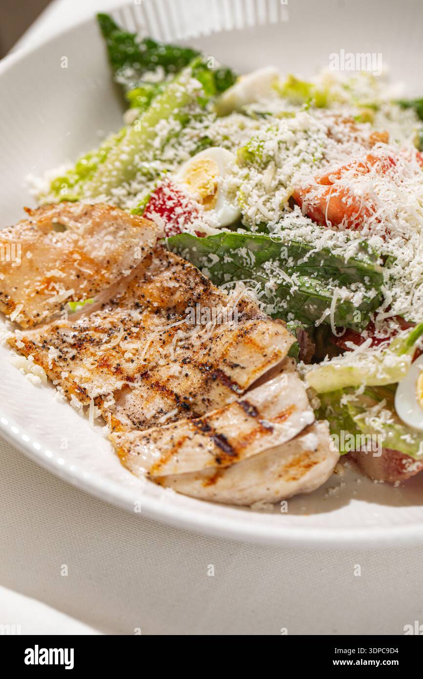 Caesar salad with grilled chicken and parmesan Stock Photo