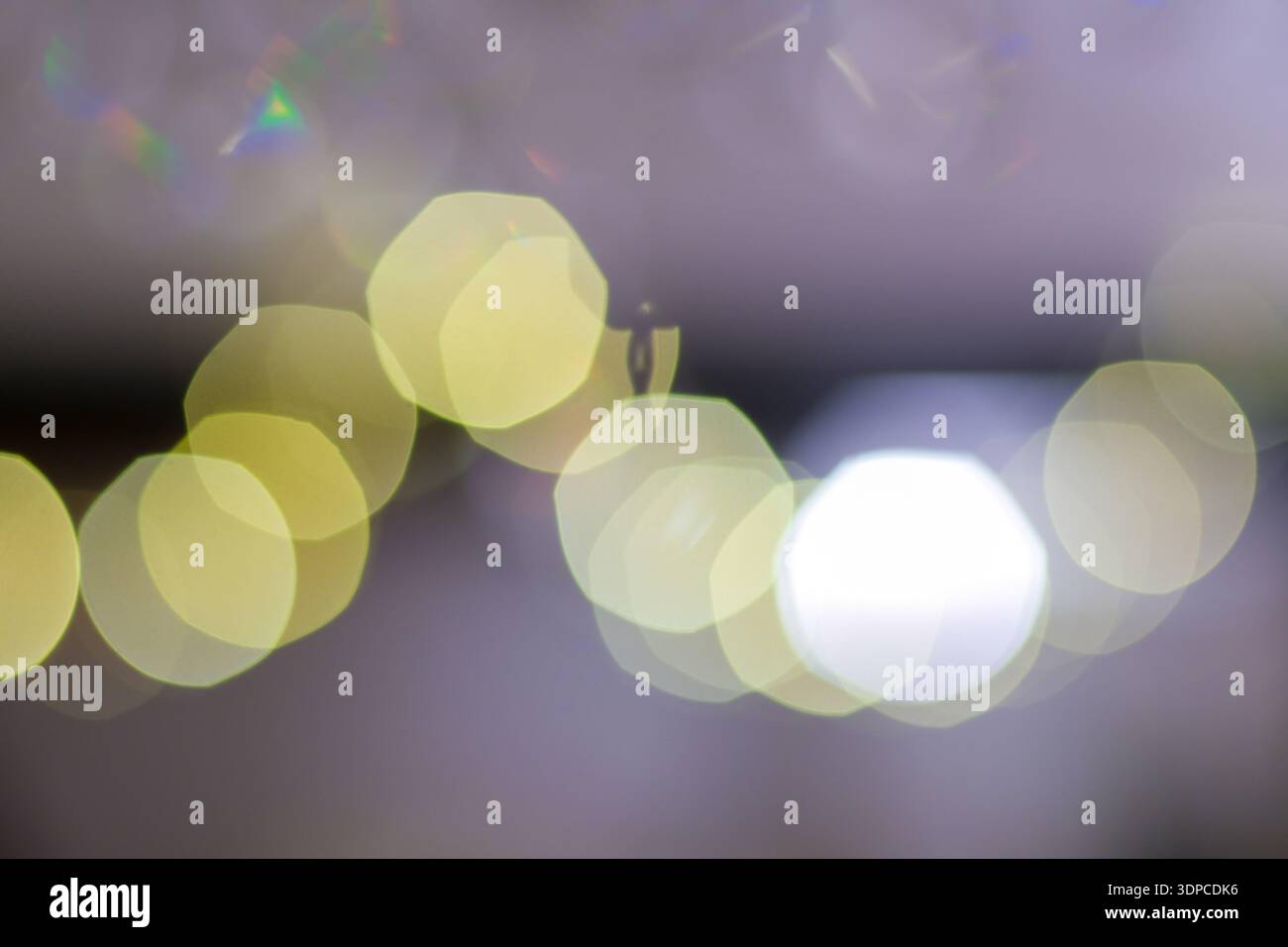 Soft focus bokeh light circles creating abstract pattern with rainbow lens flare effects Stock Photo