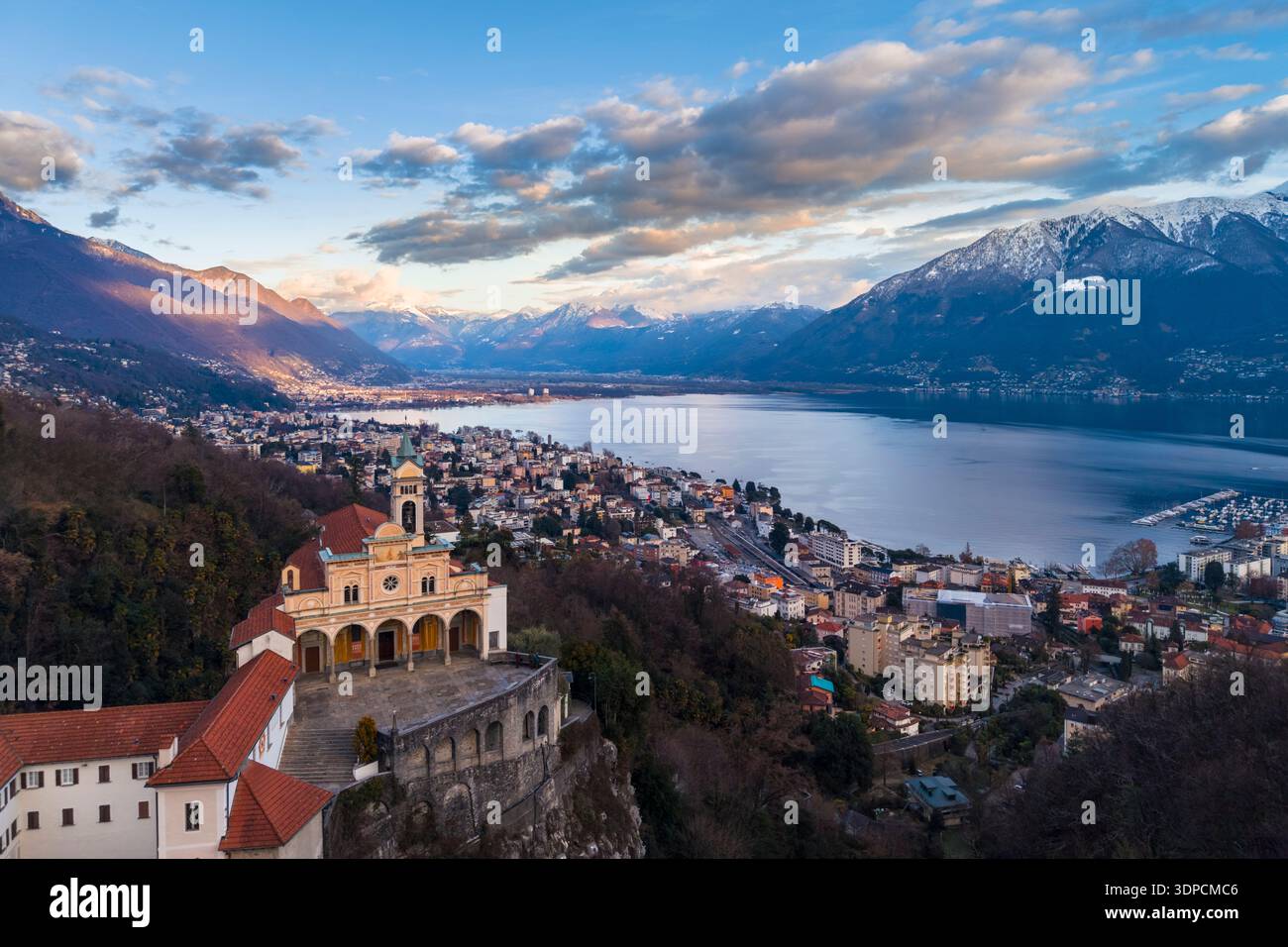 Aerial view of the church of Madonna del Sasso with a view over Lake Maggiore at sunset in winter. Orselina, Locarno, Canton Ticino, Switzerland. Stock Photo
