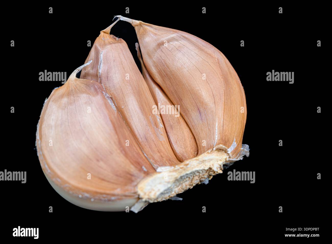 Garlic cloves isolated on black background Stock Photo