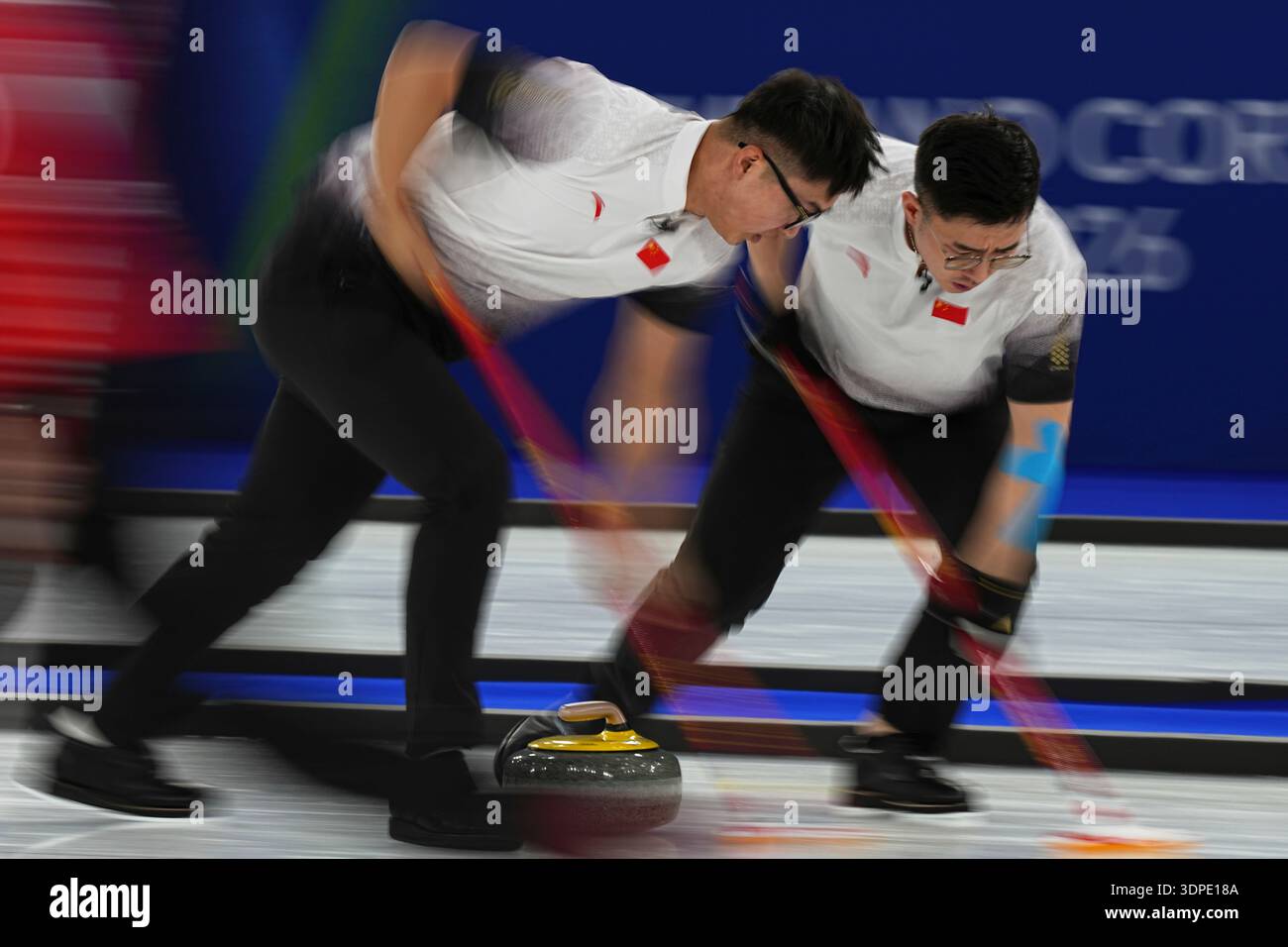 China's Li Zhichao and Xu Jingtao in action during the men's curling ...