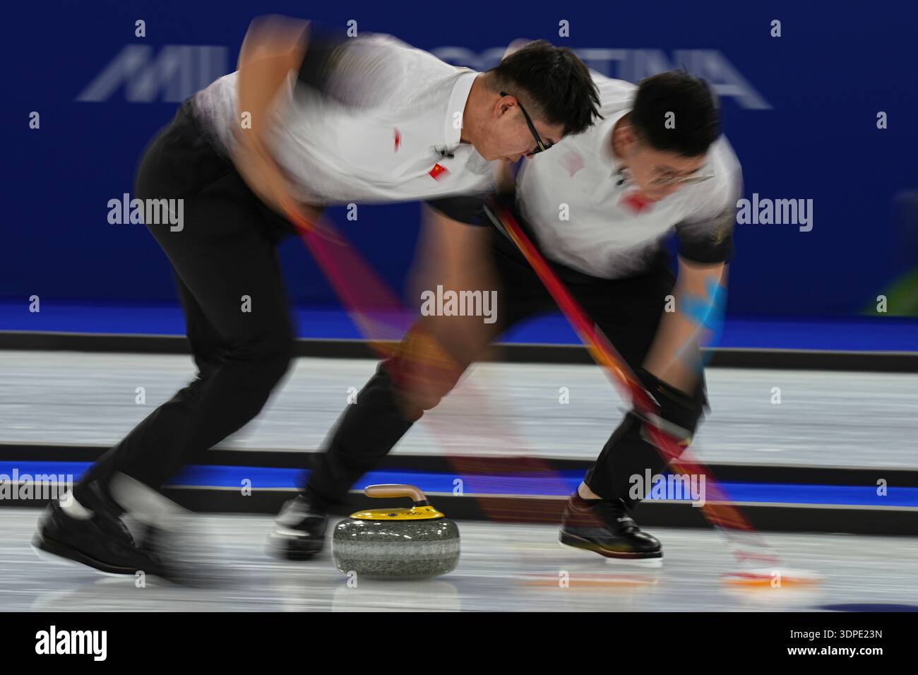 China's Li Zhichao and Xu Jingtao in action during the men's curling ...