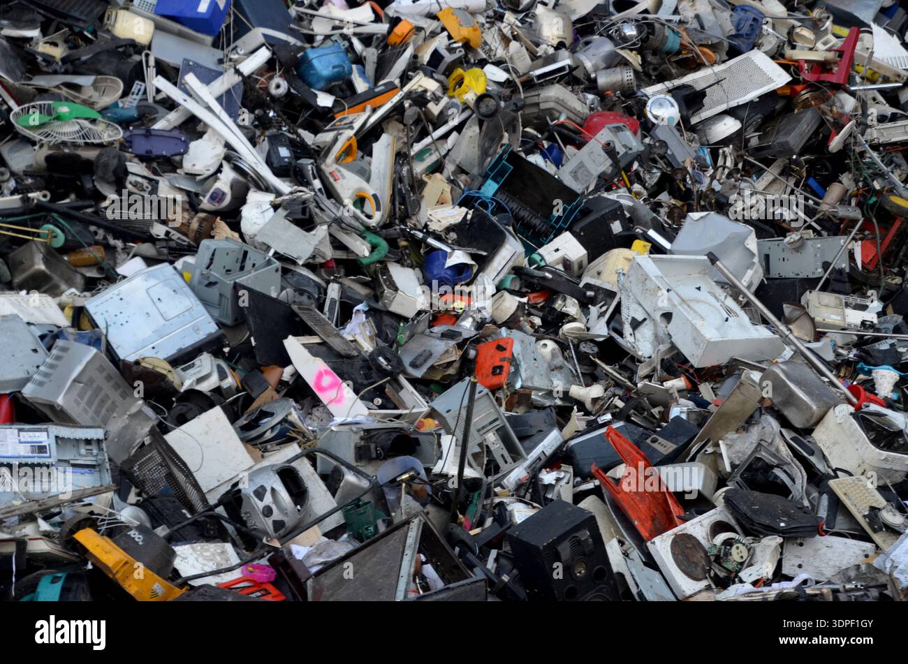 Large pile of assorted electronic waste and household appliances at a recycling center in Cyprus. Stock Photo
