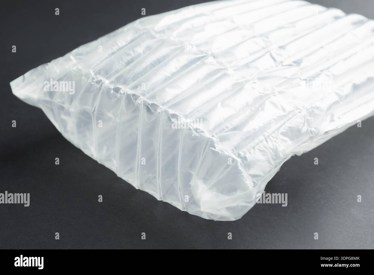 Transparent air buffer packaging on black background, closeup Stock Photo
