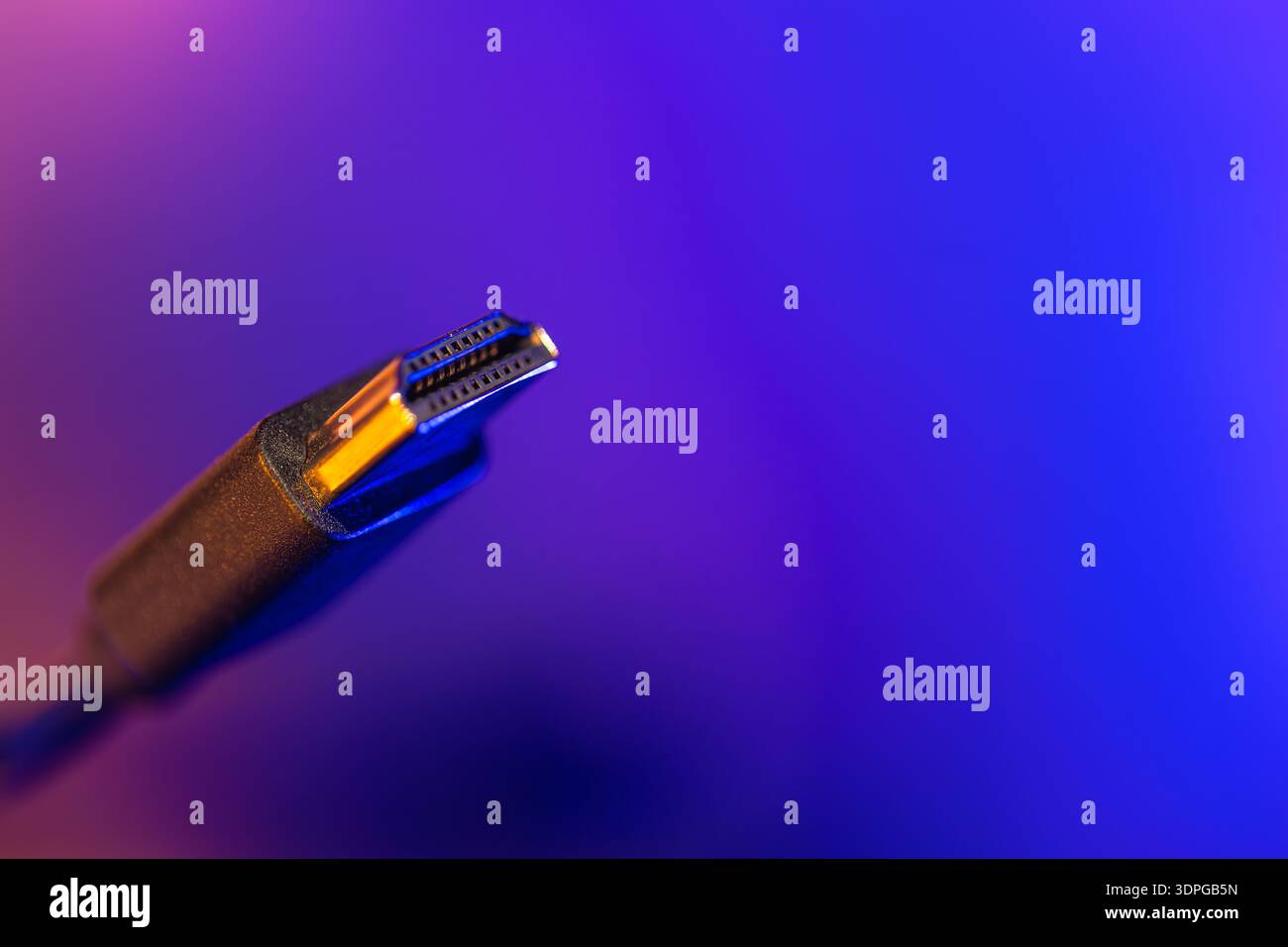 Hdmi cable on vibrant blue background. Side view connector. Stock Photo