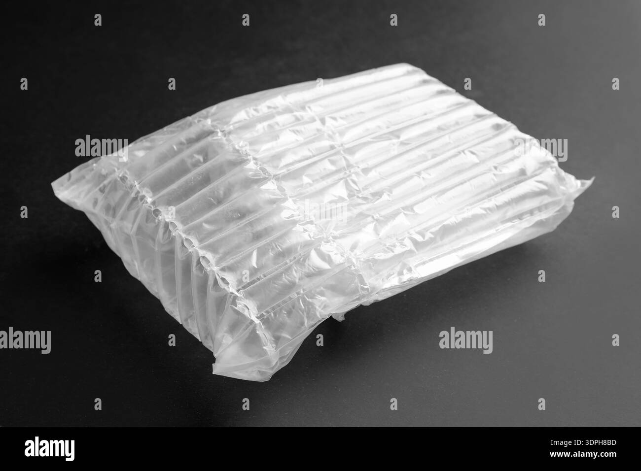 Transparent air buffer packaging on black background, closeup Stock Photo